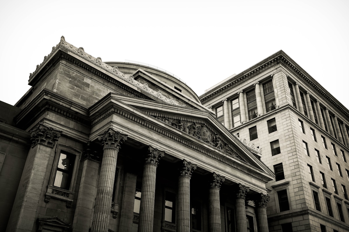 A classic neoclassical bank building facade with grand columns, representing traditional banking institutions carrying the weight of legacy data debt