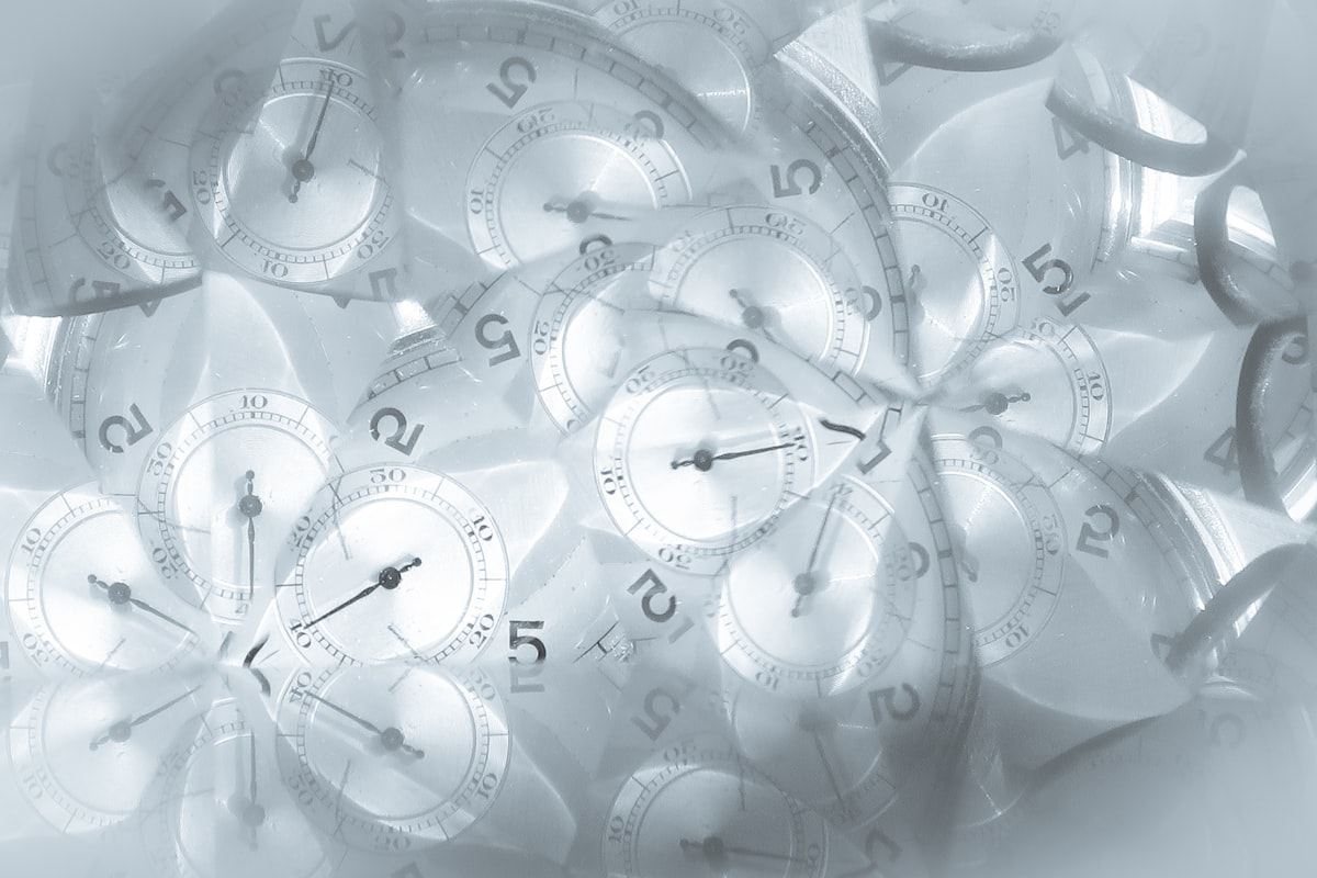 A soft monochrome collage of overlapping analog clock faces, representing the closing window and rising cost of waiting on Decision Intelligence